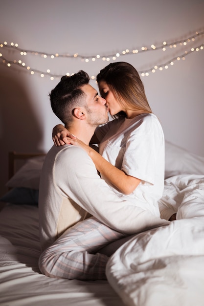 woman-man-kissing-hugging-bed-dark-room_23-2148020323.jpg