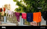 on-roof-rope-with-clean-clothes-outdoors-on-laundry-day-colorful-clothes-hanging-in-clotheslin...jpg